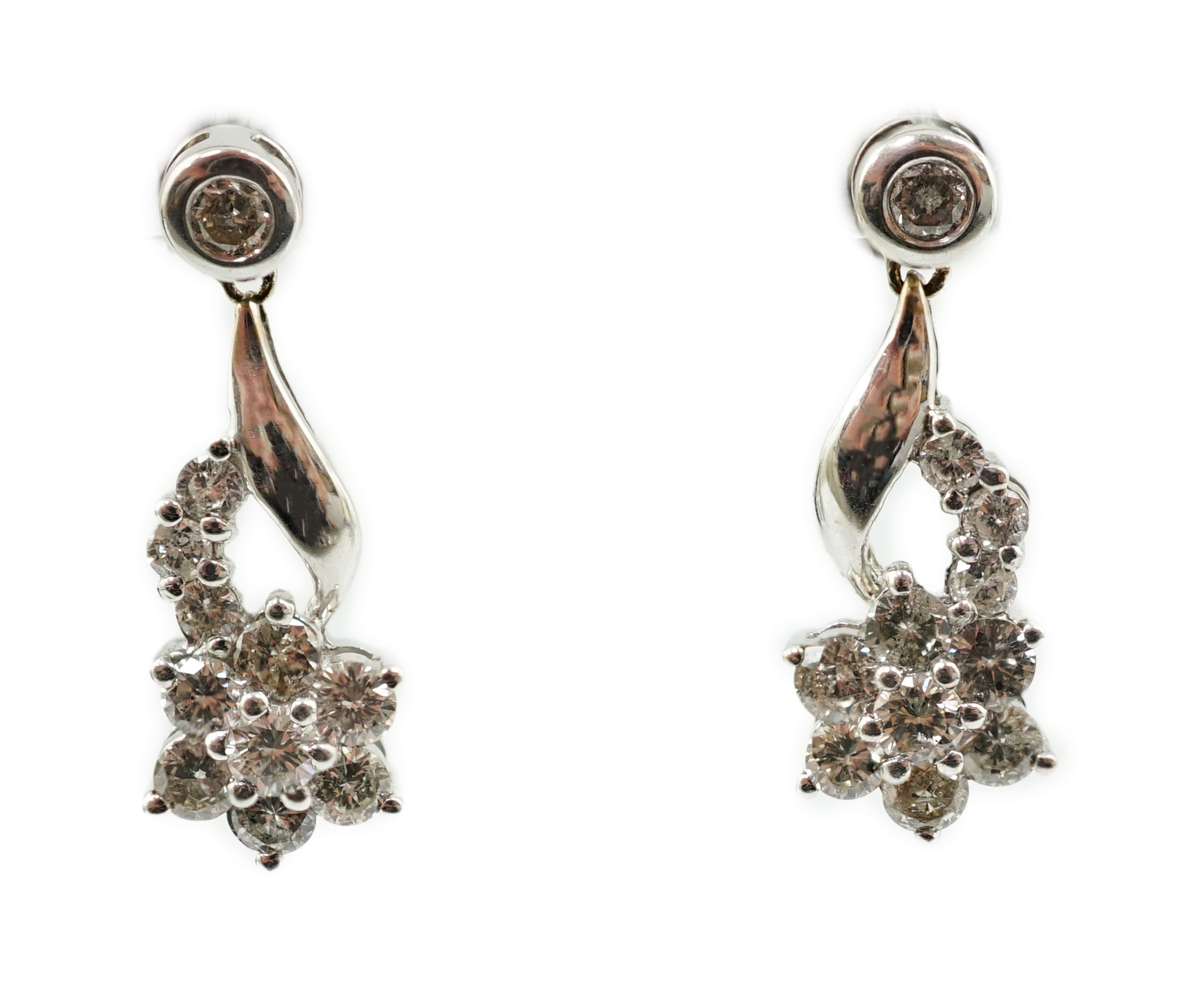 A modern pair of 18k white gold and diamond cluster ear studs, each modelled as a flower with stem